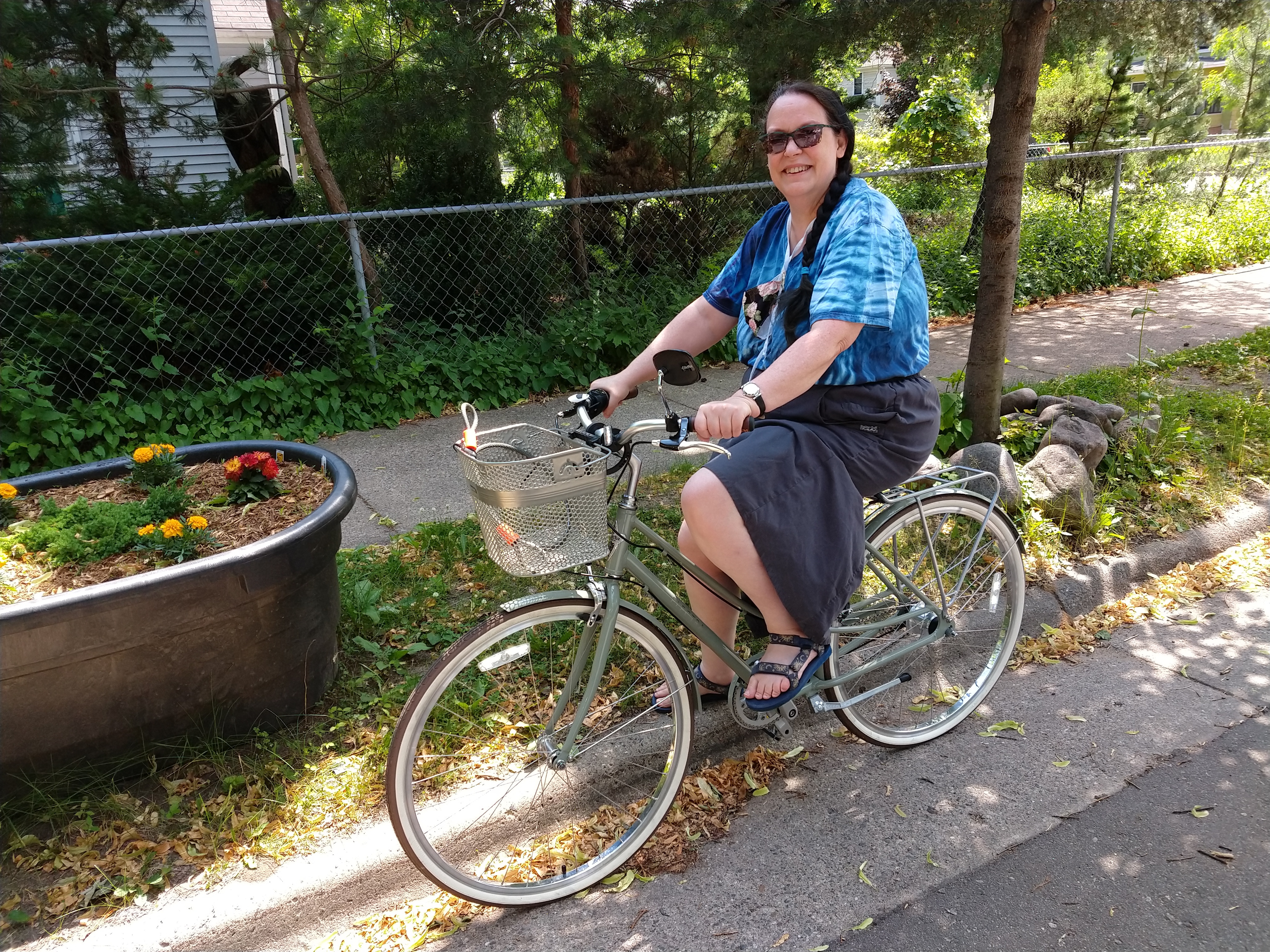Lydy on bicycle, looking smug